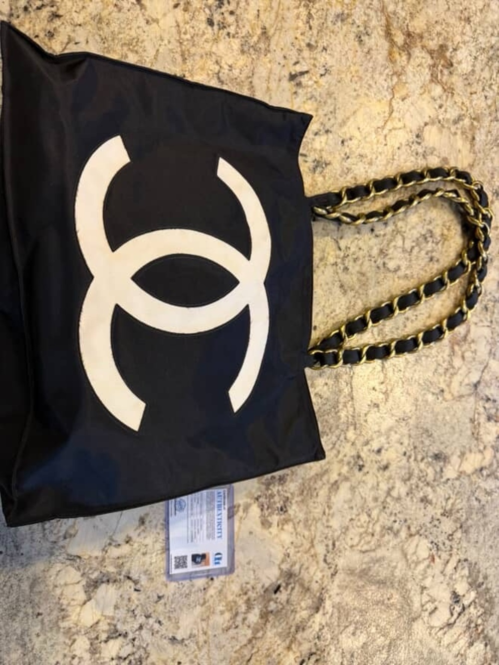 CHANEL Black Tote with White Interlocking Logo and Gold-Trim Chain Handles